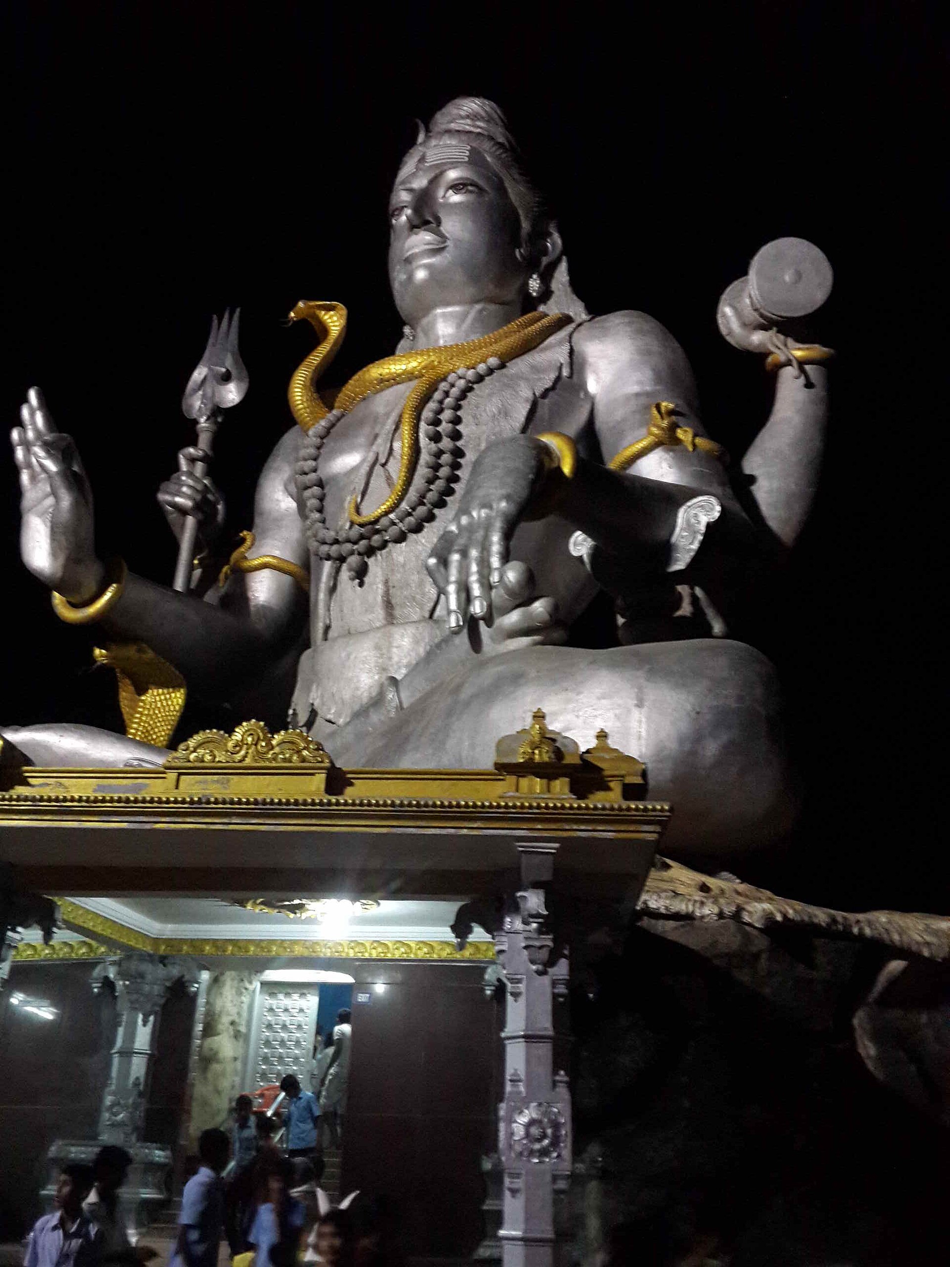 Shiva Statue | India Travel A massive Shiva statue illuminated at night atop a temple in Karnataka, showcasing Indian culture.