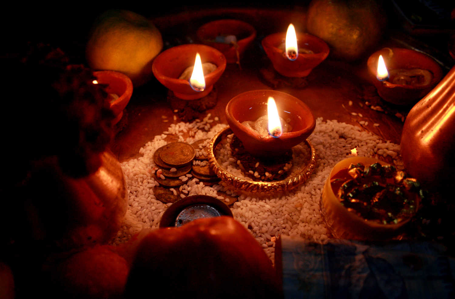 Diwali | The India Lit clay lamps and offerings are part of a Diwali ritual in India.