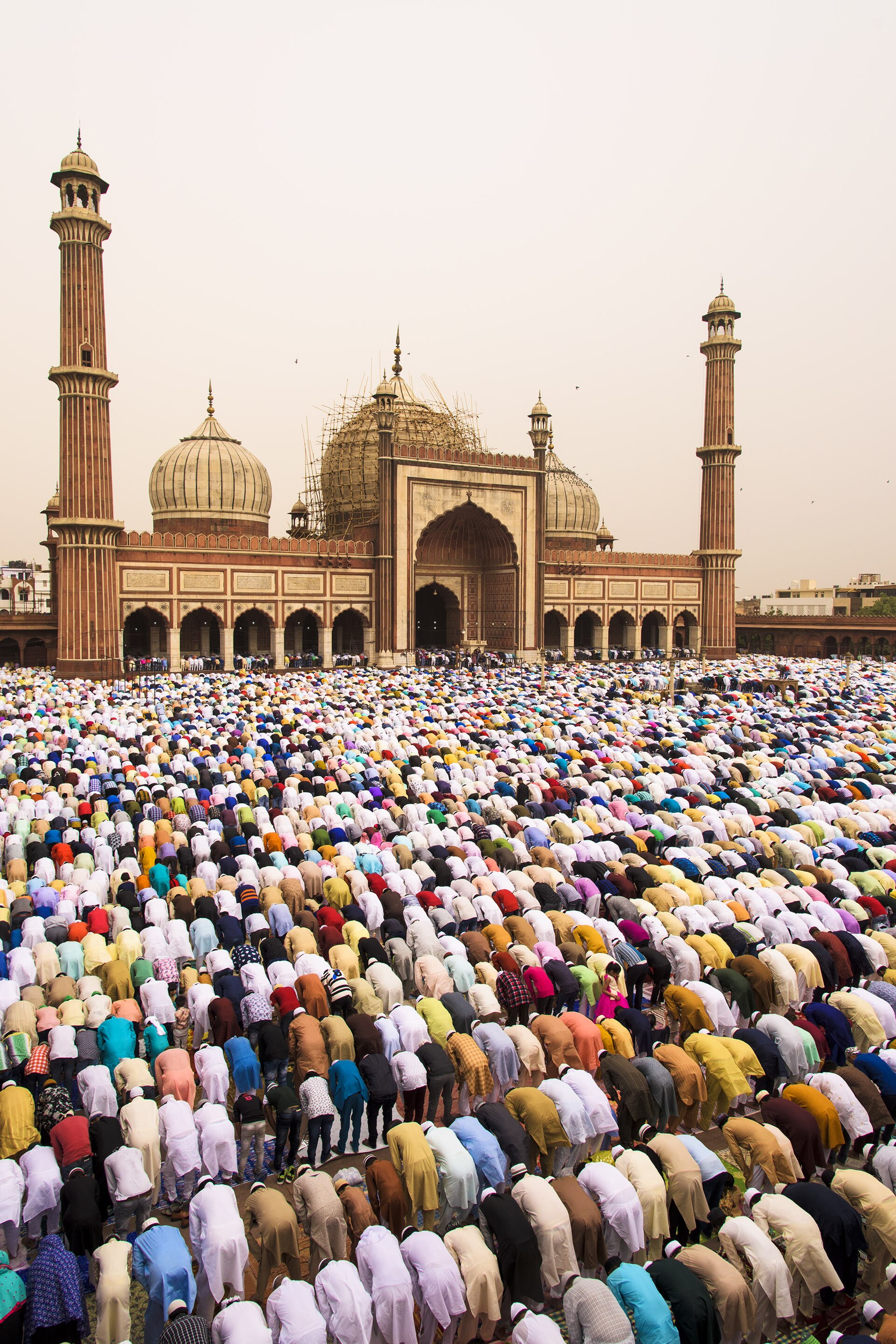 Eid at Jama Masjid | india-travel Muslim worshippers pray near Jama Masjid mosque in Old Delhi, India during Eid celebrations.