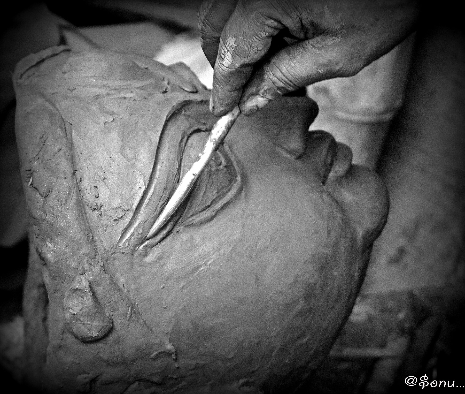 Durga Idol Creation | The India An artist carves details into a clay Durga idol during Navratri celebrations in Kolkata, showcasing Indian art.