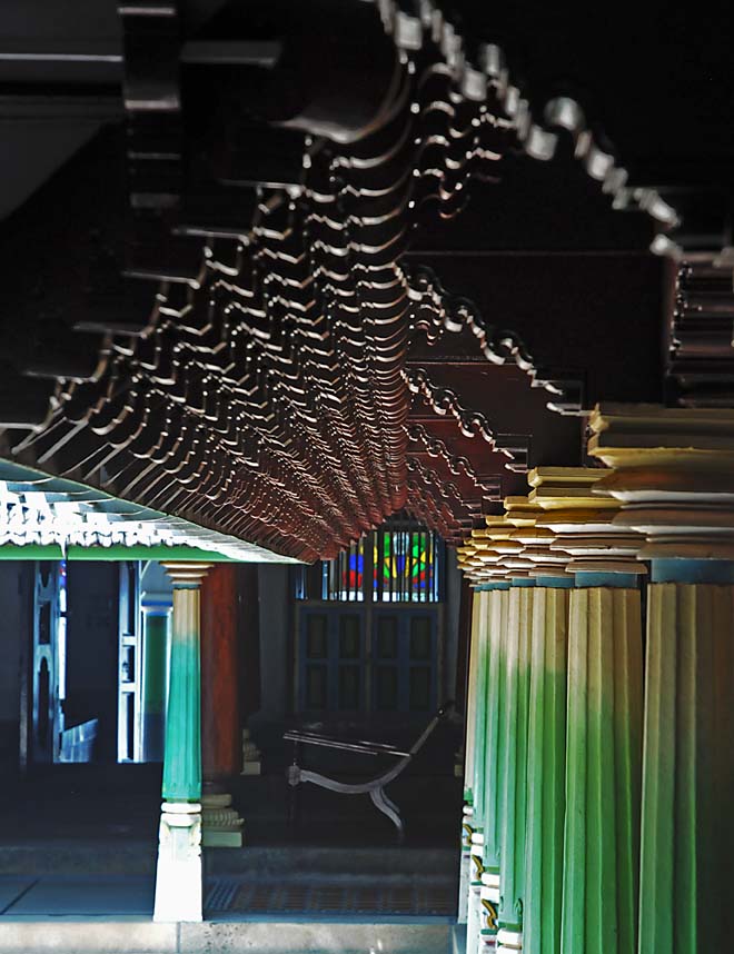 Korean Architecture | The India Traditional Korean structure with intricate roof details and green columns.