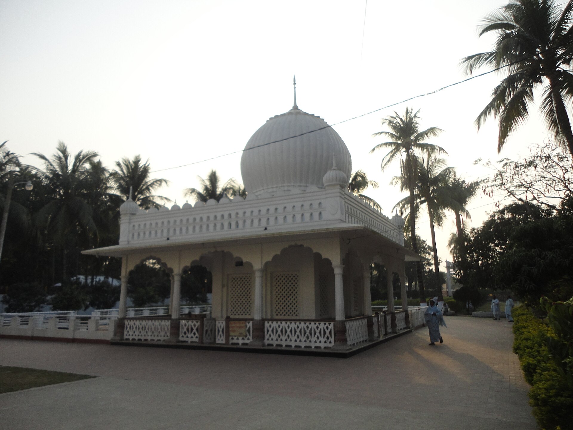 Lalon Shah Shrine | The India A white mausoleum, the shrine of Lalon Shah, stands surrounded by greenery in Bengal.