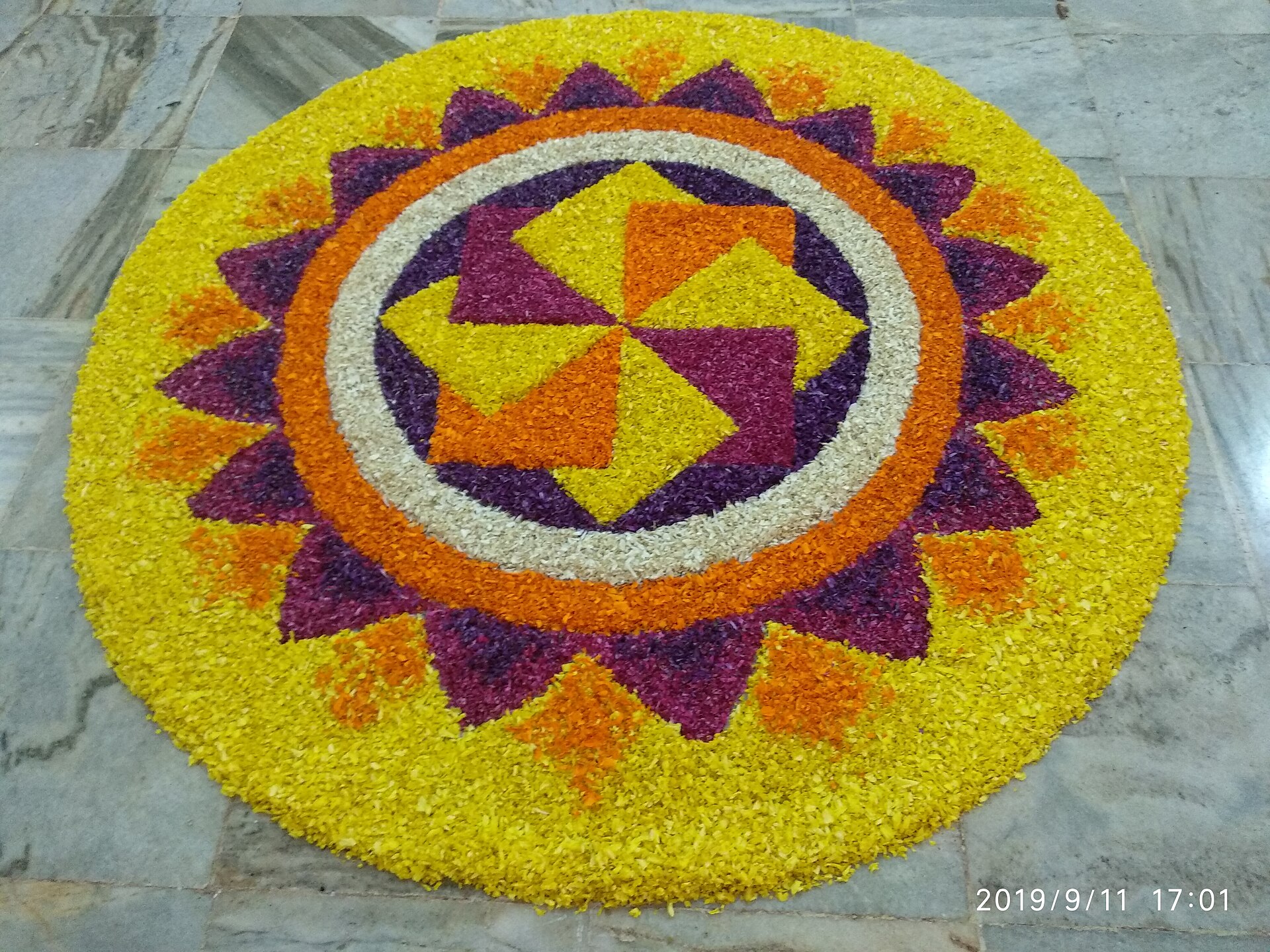 Onam Pookkalam | The India A colorful pookalam flower arrangement is displayed for the Onam festival in Kerala, celebrating India's harvest.