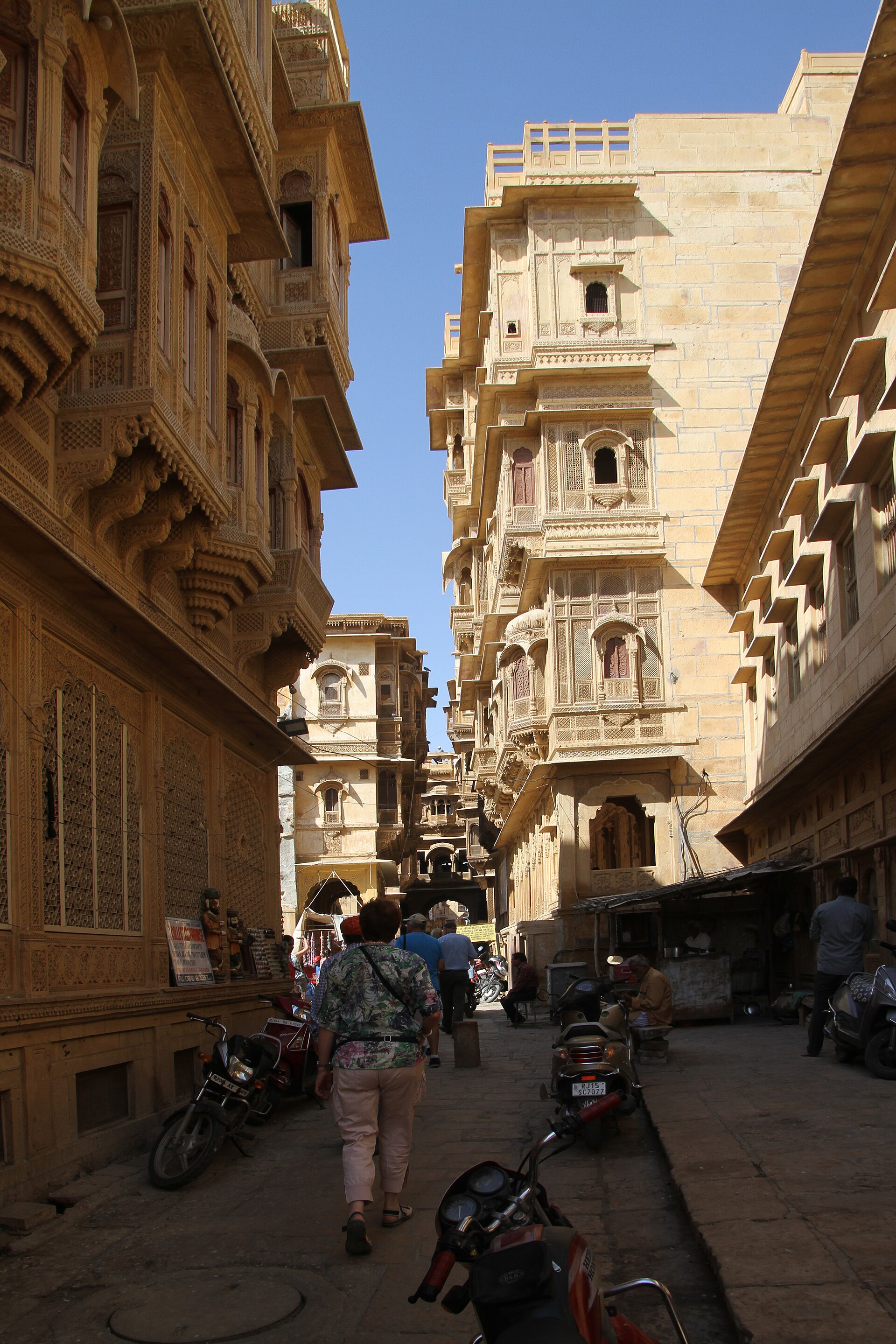 Rajasthani Haveli | The India A street in Jaisalmer, India shows sandstone buildings and traditional Rajasthani architecture.