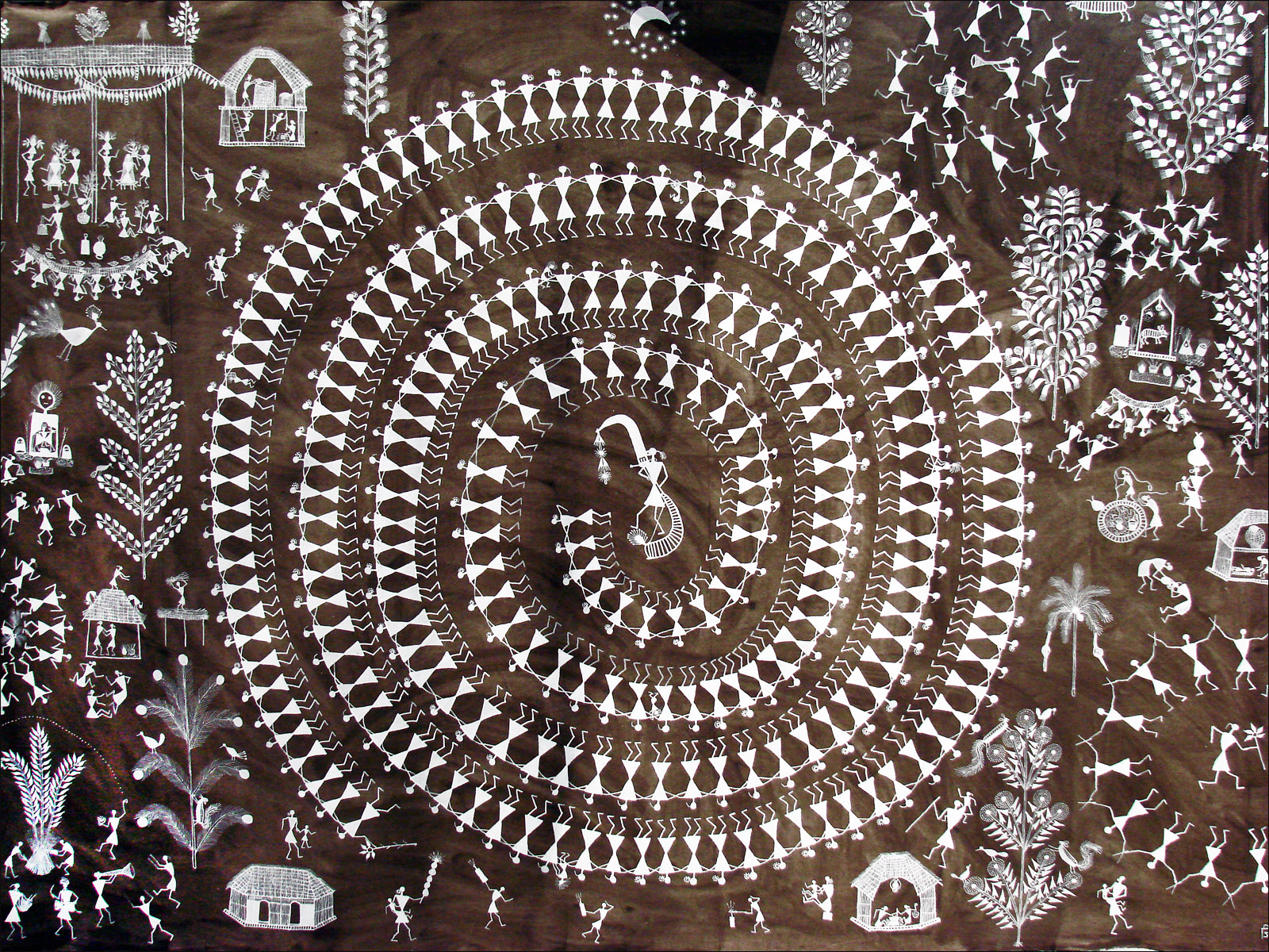 Warli Art | The India A traditional Warli painting depicts a community celebrating around a central deity, showcasing vibrant Indian culture.